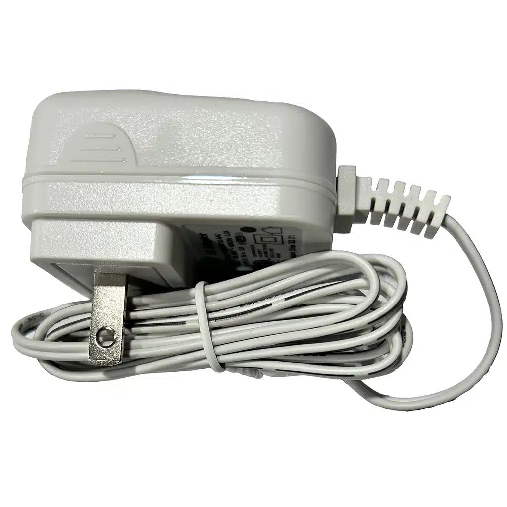 White Chattanooga replacement power adapter charger with coiled power cord for Cefar TENS and NMES units on a white background.