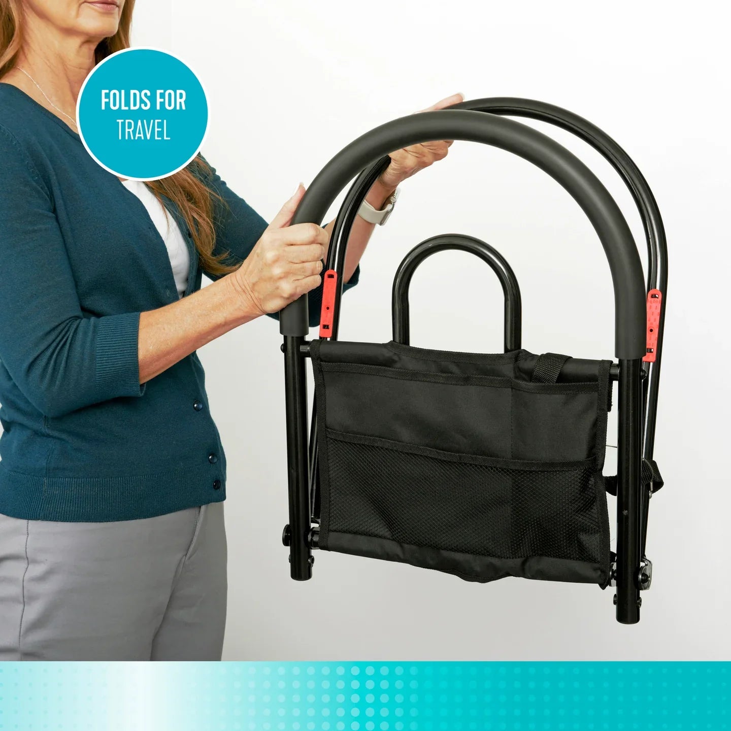 Woman holding folded Stander Bed Rail Advantage Traveler #5000 with black organizer pouch.
