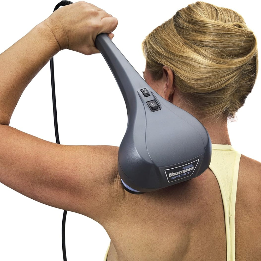 The massager being applied to the shoulder and upper back area to relieve stiffness and muscle tension.