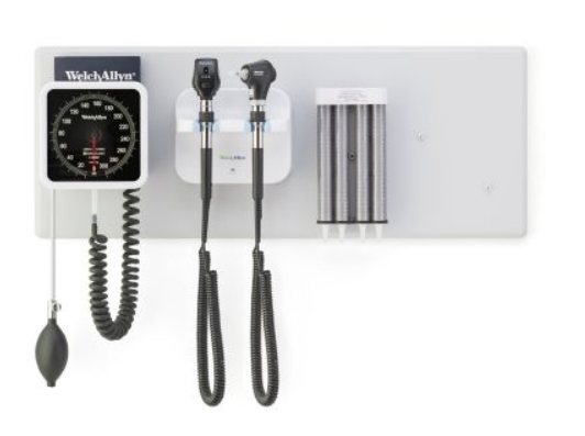 Welch Allyn wall-mounted diagnostic system with blood pressure gauge, otoscope, ophthalmoscope, and specula dispenser on a white background.