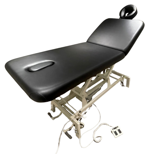 Black massage table with adjustable base on a white background