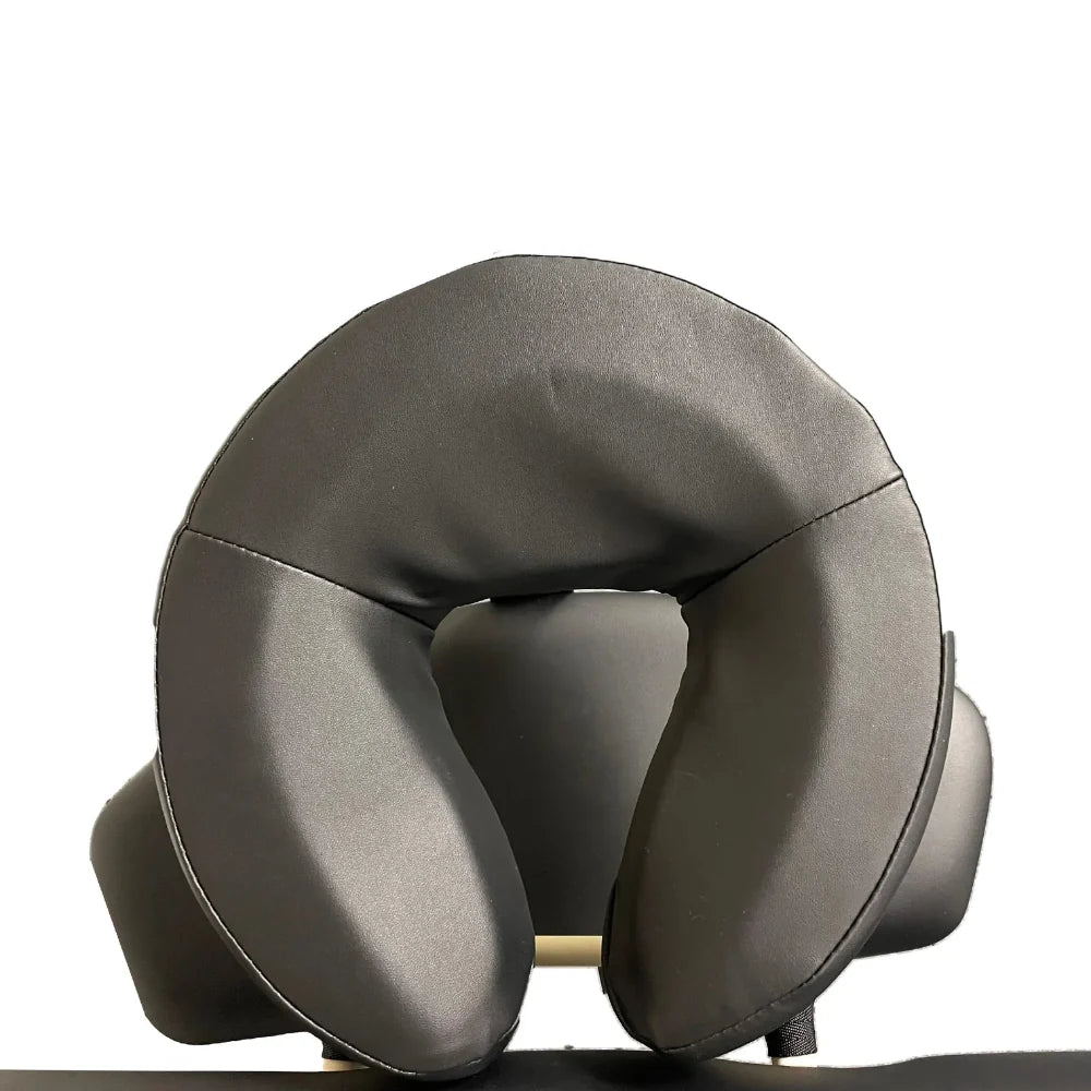 Close-up detail of the ergonomic black contoured headrest cushion included with the A-Lek flat top electric massage table for optimal patient comfort.
