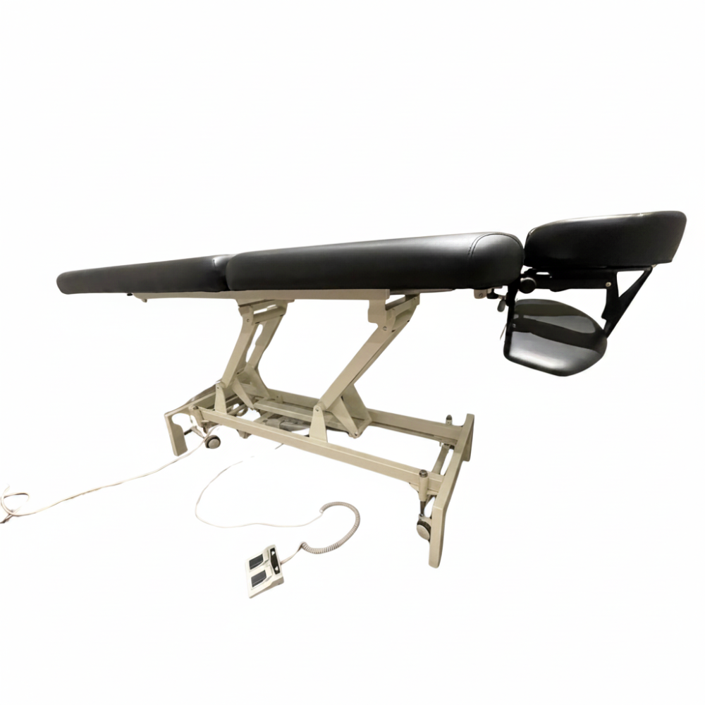 Side angled profile view of the black 2-section electric height control facial massage treatment table laid fully flat, showcasing its sturdy white steel lifting frame and sleek cushioning.
