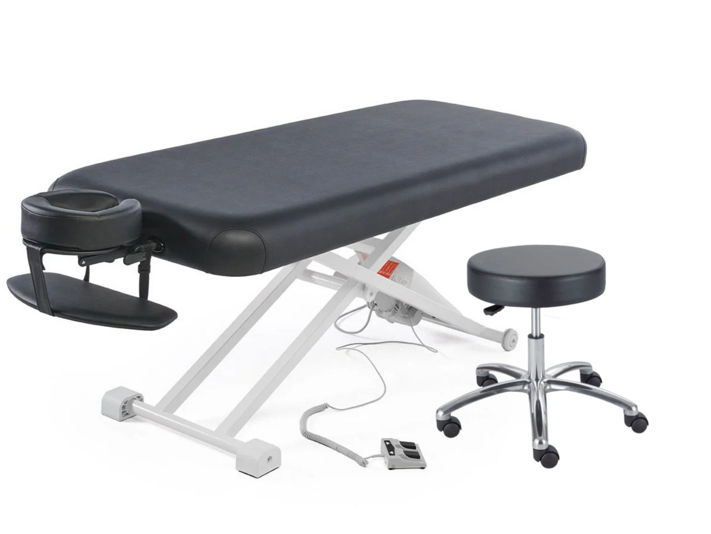 Black flat top electric massage table with attached face cradle, foot pedal control, and matching black hydraulic rolling stool on a white background.