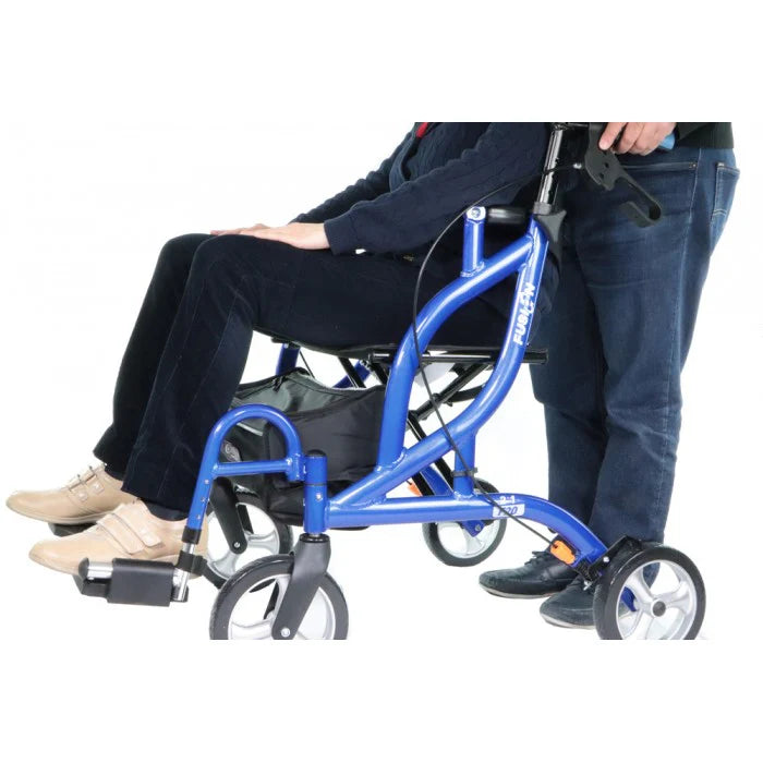A person being pushed in the Airgo Fusion while in transport chair mode, demonstrating the swing-away footrests and safety lap belt.