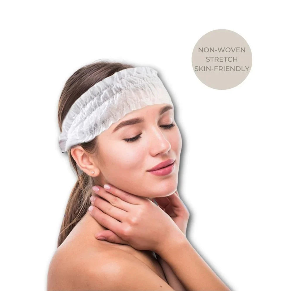 Woman wearing a white disposable non-woven headband with her eyes gently closed, featuring a badge in the corner that reads "NON-WOVEN STRETCH SKIN-FRIENDLY".