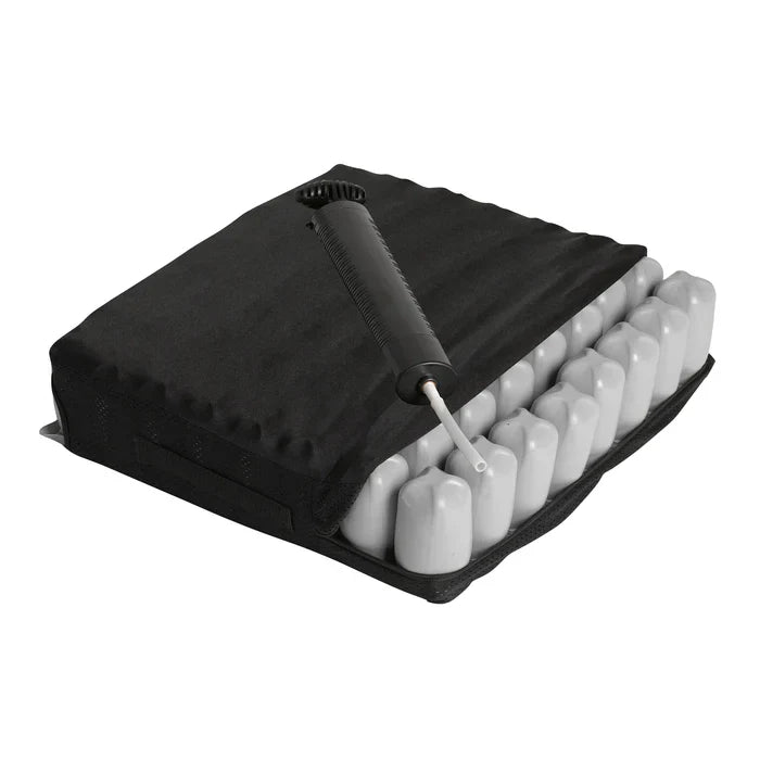 Black inflatable air cell wheelchair seat cushion featuring a removable cover, exposed interconnected air cells, and an attached manual hand inflation pump on a white background.