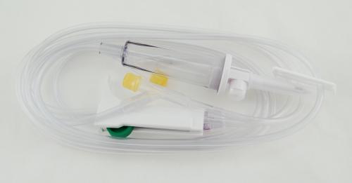Clear sterile IV tubing extension set coiled on a plain white background.