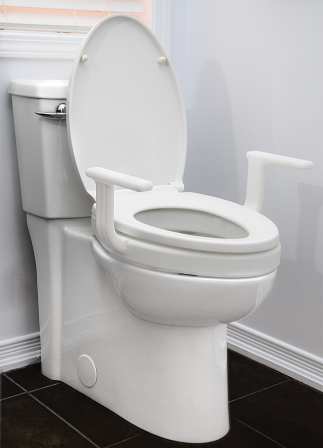 White Mobb 2-inch raised toilet seat extension with handles installed on a porcelain toilet