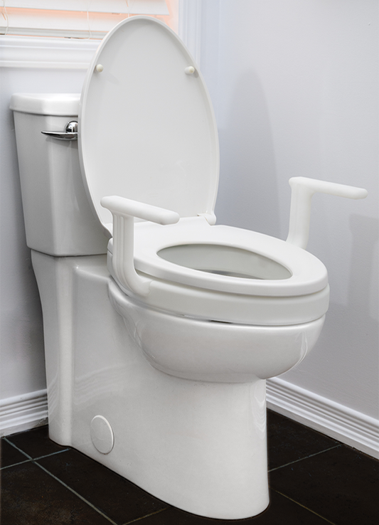 White Mobb 2-inch raised toilet seat extension with handles installed on a porcelain toilet