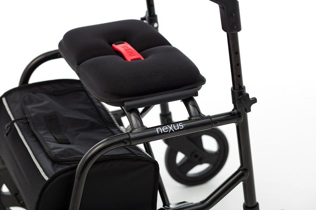 Close-up of the NeXus 3 black rollator's contoured seat and frame, emphasizing the high-quality finish and cable-free architecture.