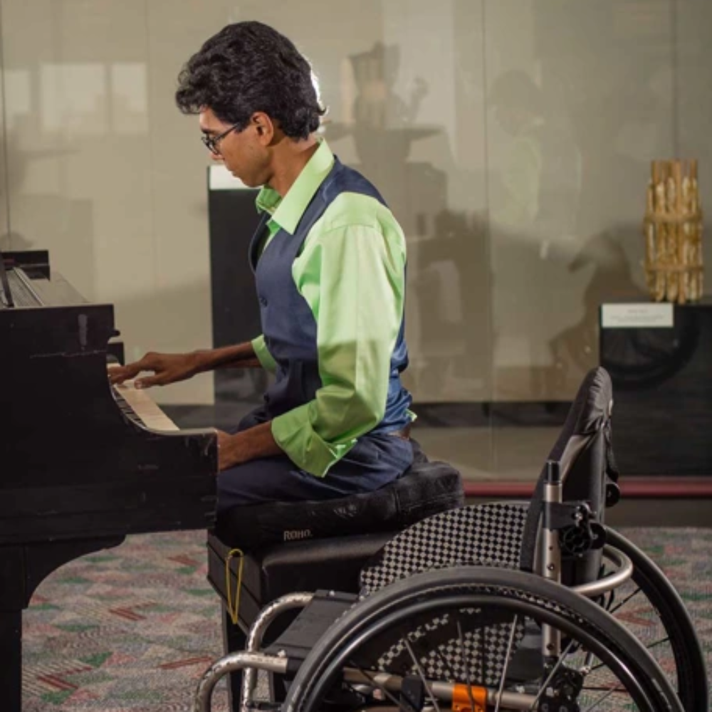 A person using the ROHO Mosaic cushion in a wheelchair, illustrating how the air cells provide stable and comfortable seating for everyday mobility.