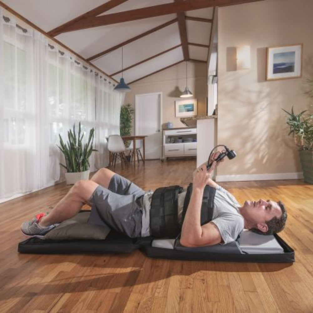 An overhead view of a lumbar traction session, showcasing the alignment and support provided by the clinical-grade harnesses during treatment.