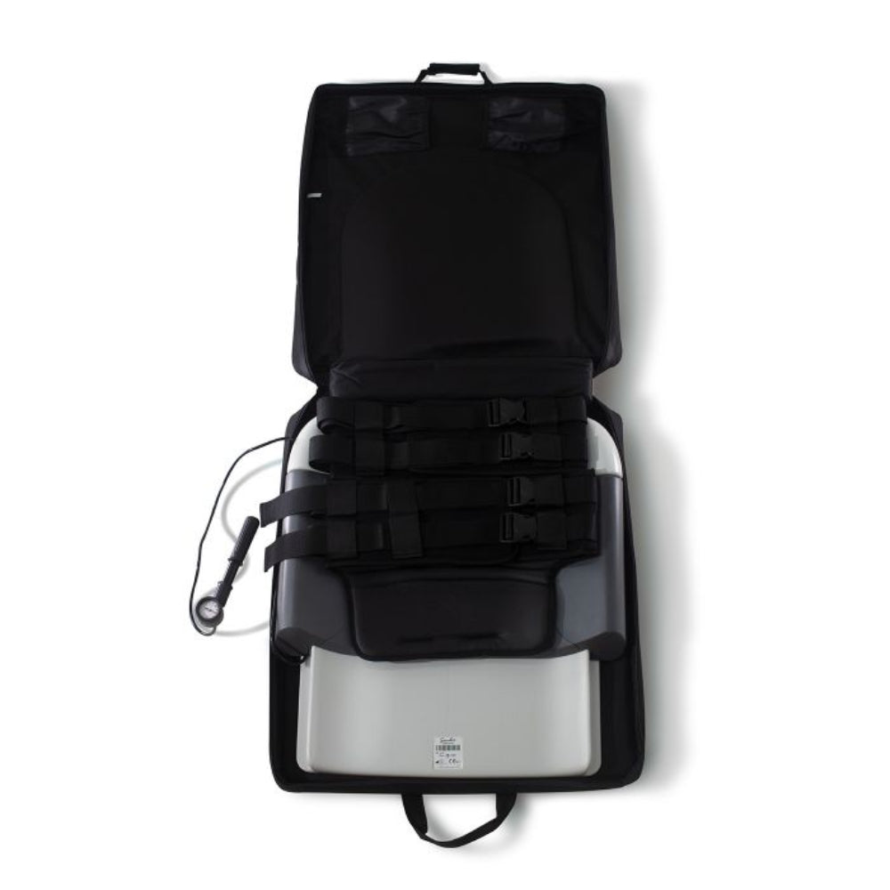 An open view of the lumbar traction system showing the high-pressure pneumatic pump and the secure belt harnesses used for lower back decompression.