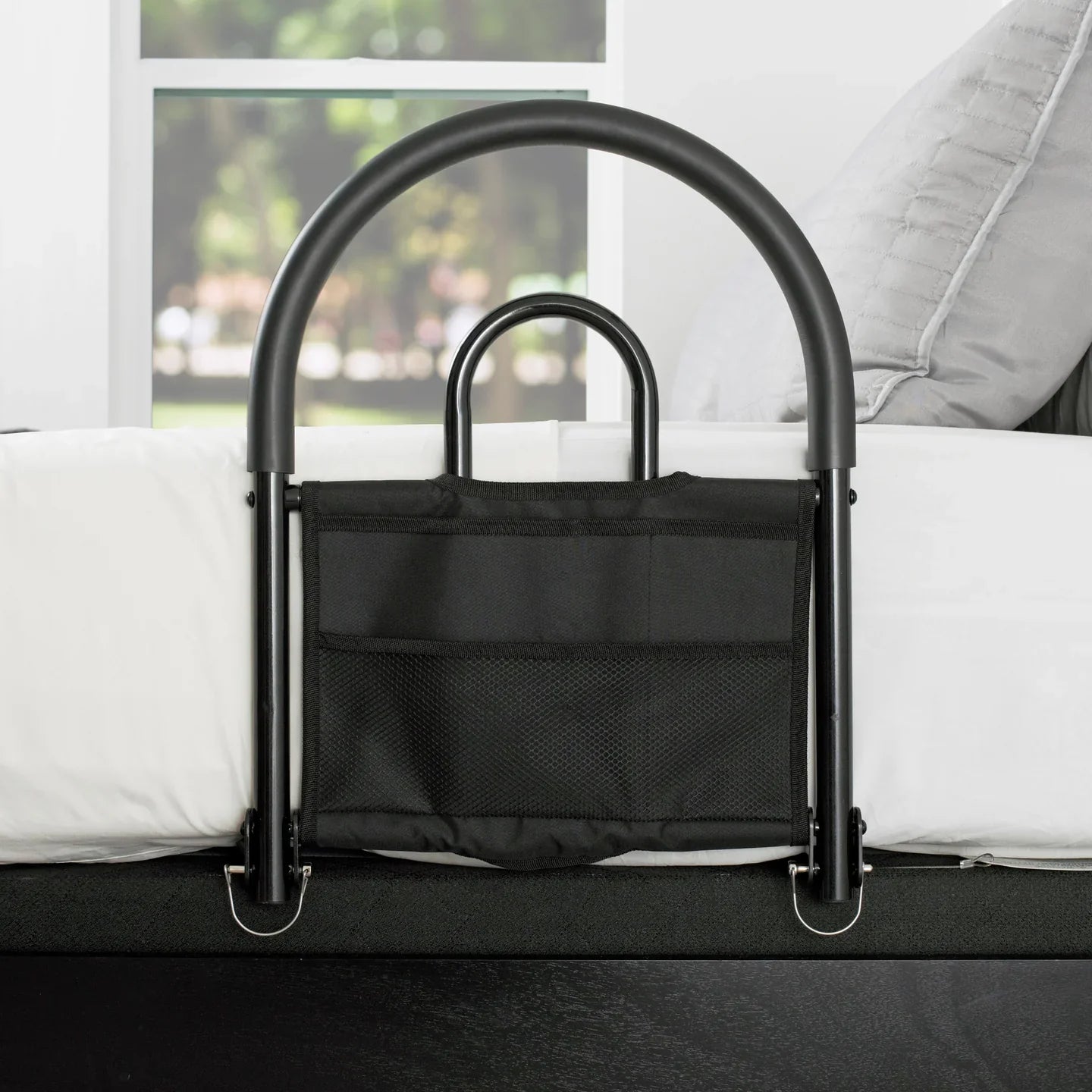 Black Stander Bed Rail Advantage Traveler assist handle with attached organizer pouch installed on a mattress and bed frame setup.