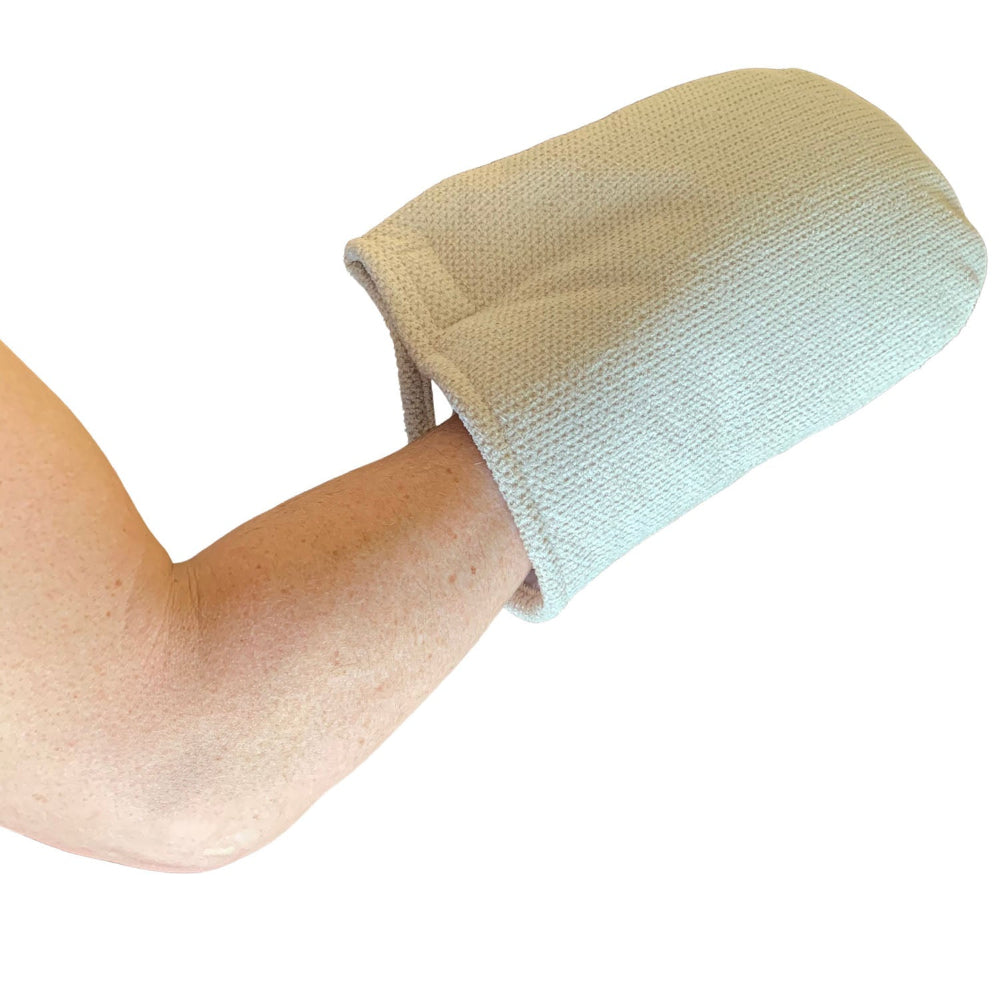 A person wearing a Therabath insulated mitt during a treatment session, demonstrating how the mitt covers the hand to prolong the soothing effects of paraffin.