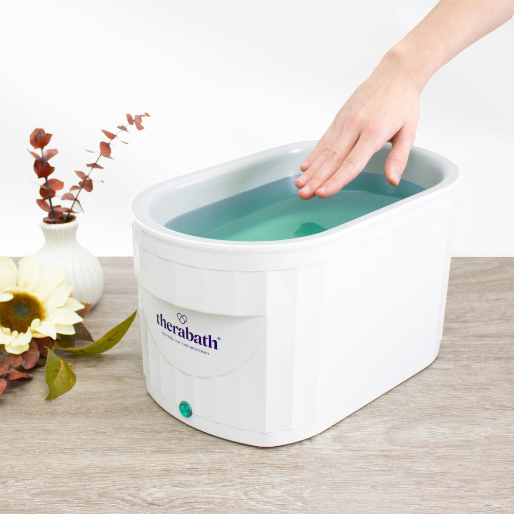 The Therabath TB6 unit providing therapeutic heat to the hand area, helping to increase blood flow and soften dry, cracked skin.