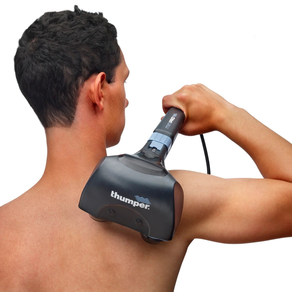 A person using the massager on their upper back and neck area to release muscle knots and tension.