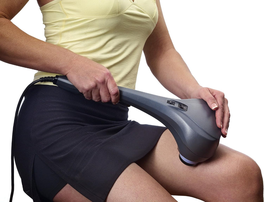 A person using the Thumper Sport on their hamstring, demonstrating the massager's effectiveness for large muscle groups.