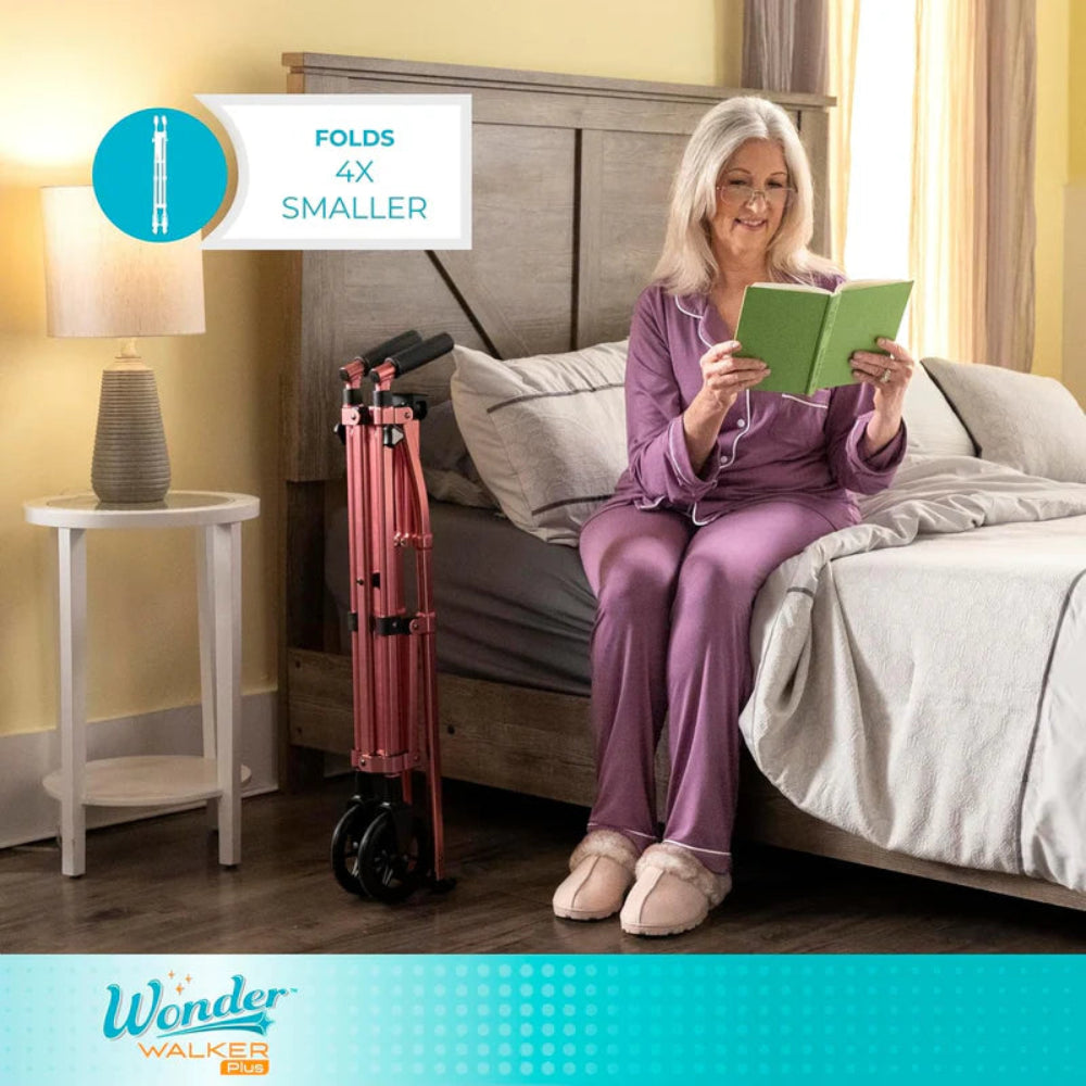 A person using the Let's Go Indoor Rollator for stability while walking through a bedroom.