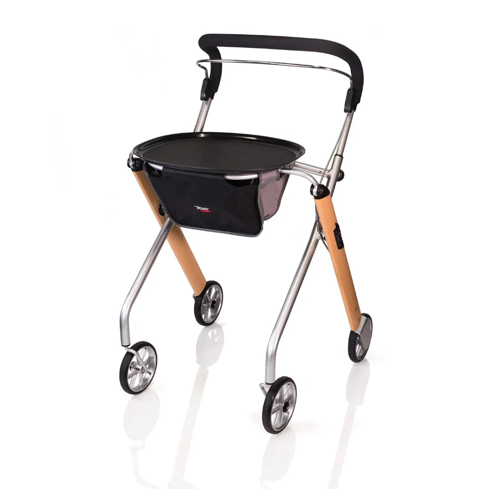 Standalone angled view of the Trust Care Let's Go Indoor Rollator in beech and silver, featuring a narrow design, full-length padded handle, and a removable tray for transporting meals.