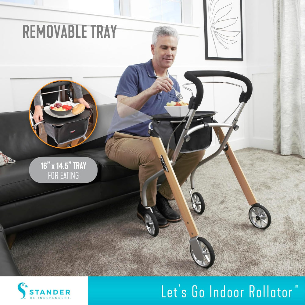 The indoor rollator parked next to a recliner, showing how it provides a stable surface for users to stand up or sit down safely.