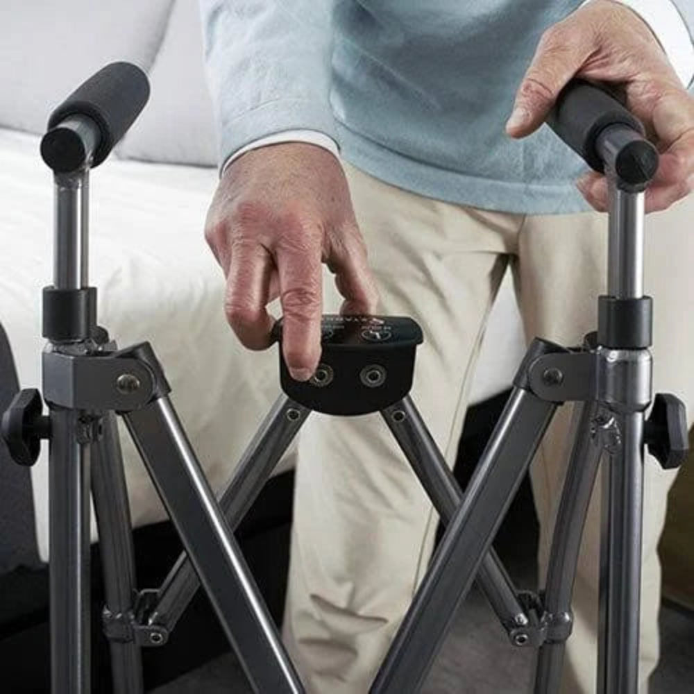 A person demonstrating how the Let's Go Indoor Rollator folds flat for easy storage .