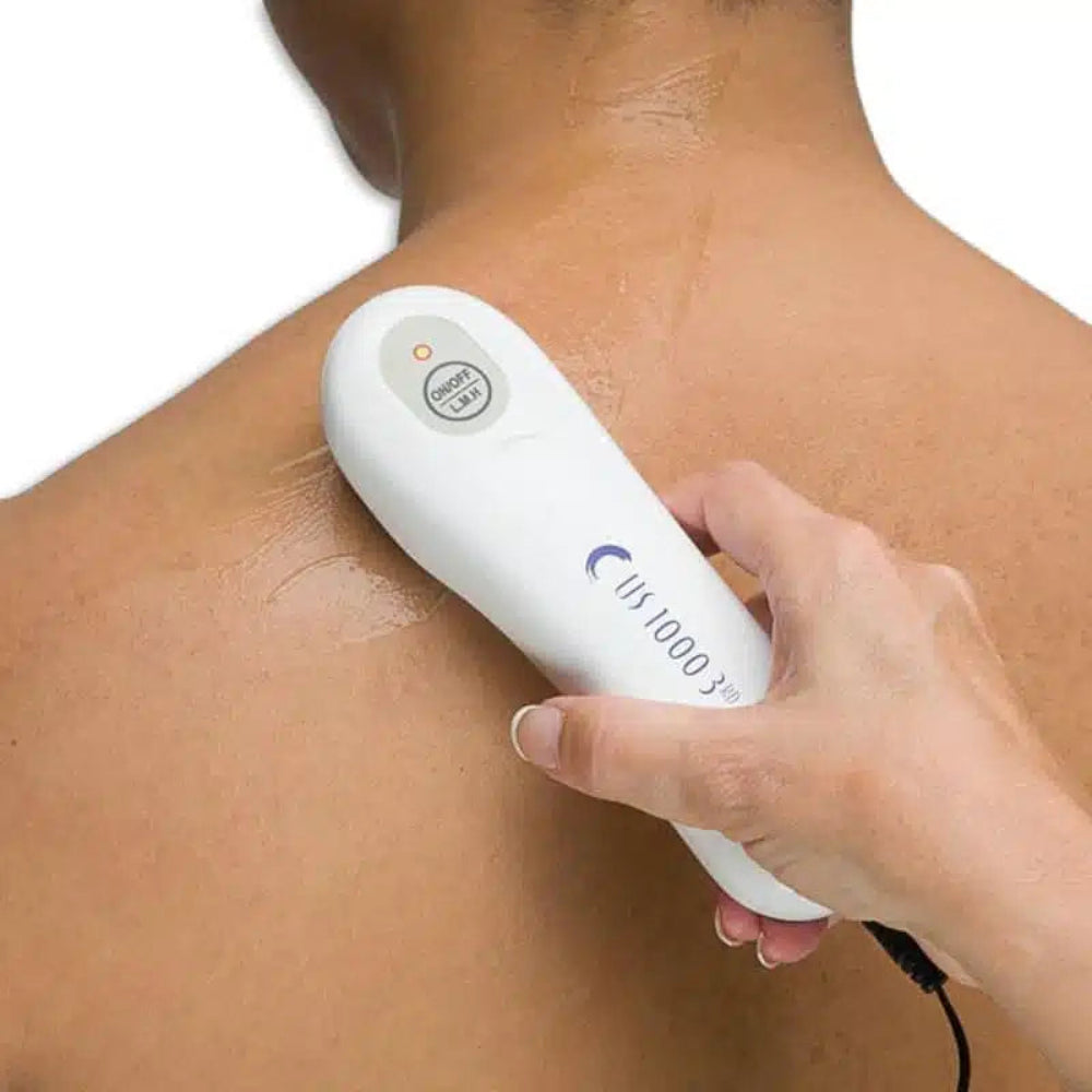 A person applying the US 1000 portable ultrasound device to the back of the neck to relieve muscle tension and chronic pain.