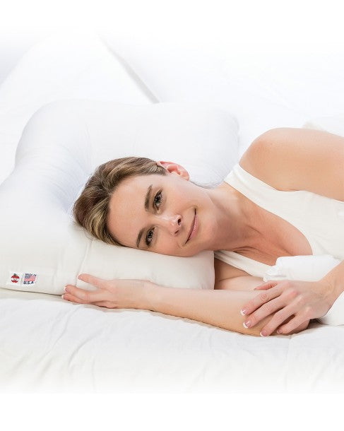 A lifestyle image showing a person sleeping on the D-Core Cervical Support Pillow, demonstrating how the D-shaped indentation maintains proper cervical alignment.